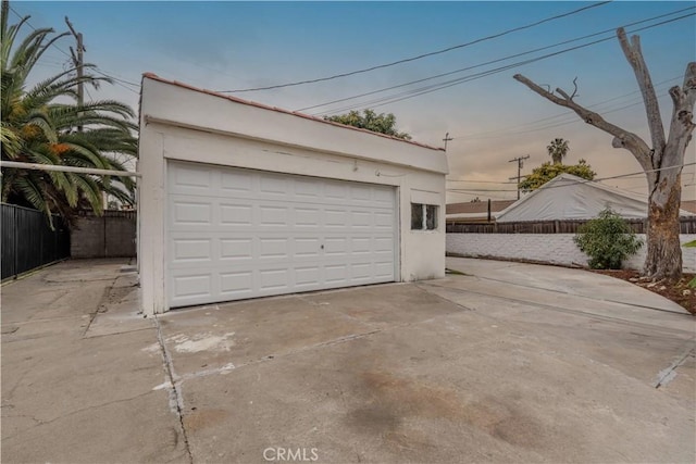 view of garage at dusk