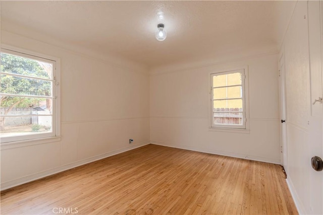 empty room with light hardwood / wood-style floors