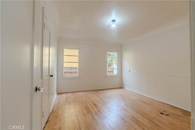 spare room featuring light hardwood / wood-style flooring