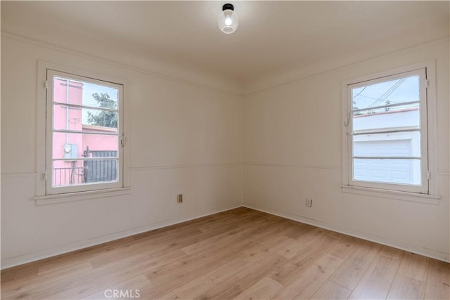 empty room with light hardwood / wood-style floors