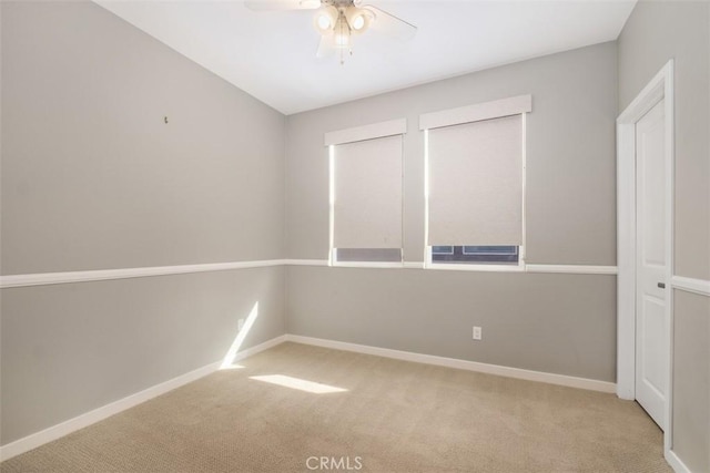 unfurnished room featuring ceiling fan and light carpet