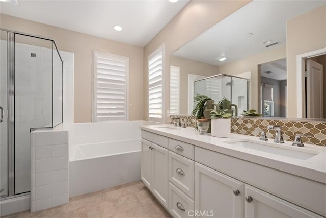 bathroom with vanity, tasteful backsplash, tile patterned floors, and plus walk in shower