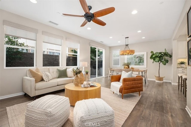 living room with ceiling fan and dark hardwood / wood-style flooring