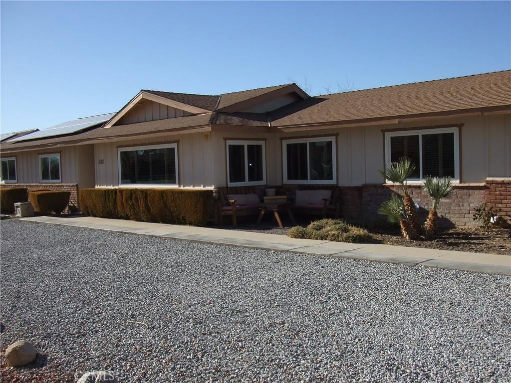 ranch-style home featuring solar panels