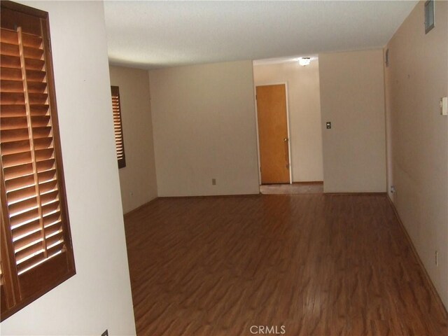 unfurnished room with wood finished floors
