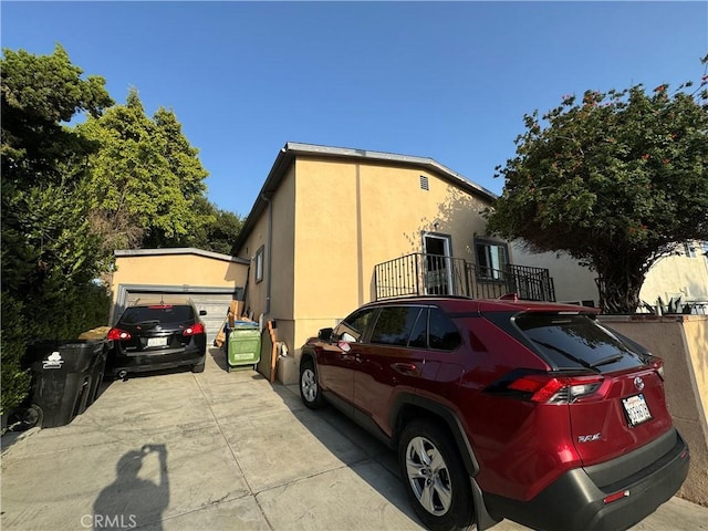 view of side of home with a garage and an outdoor structure