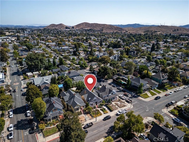 drone / aerial view featuring a residential view and a mountain view