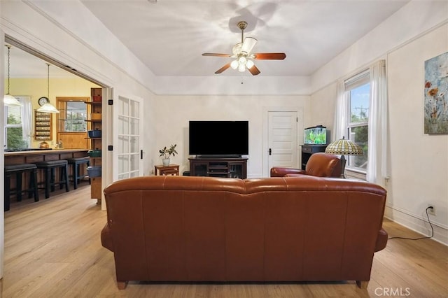 living room featuring ceiling fan and light hardwood / wood-style floors