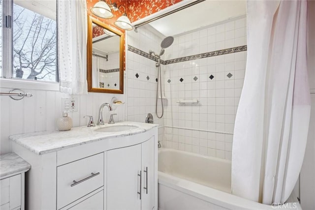 bathroom featuring vanity and shower / bathtub combination with curtain