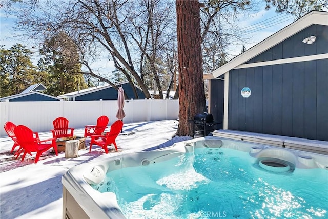 snow covered pool with a grill and a hot tub