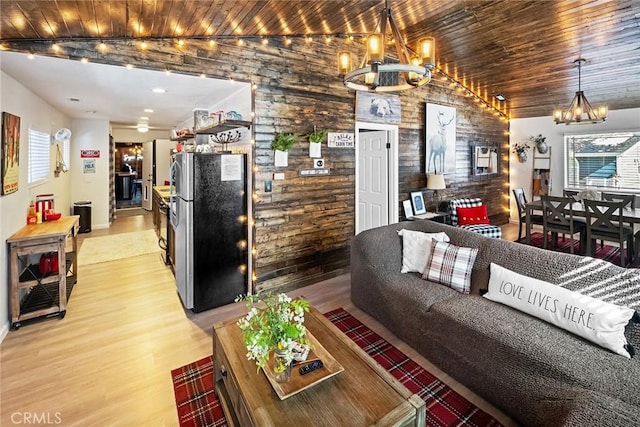 living room featuring an inviting chandelier, wood ceiling, and light hardwood / wood-style floors