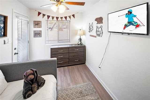 interior space with ceiling fan and wood-type flooring