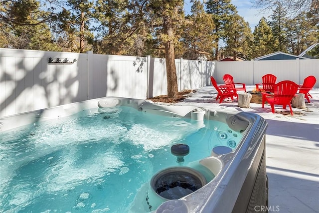 view of pool with a hot tub, a patio area, and an outdoor fire pit