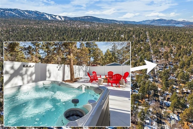 view of swimming pool featuring a mountain view and a hot tub