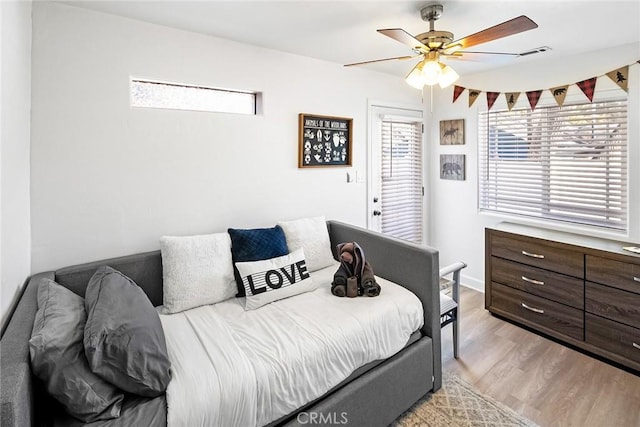 bedroom with ceiling fan and light hardwood / wood-style floors