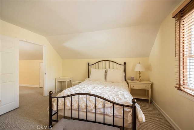 carpeted bedroom with vaulted ceiling