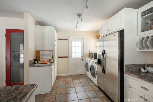 washroom with rail lighting and washer and dryer