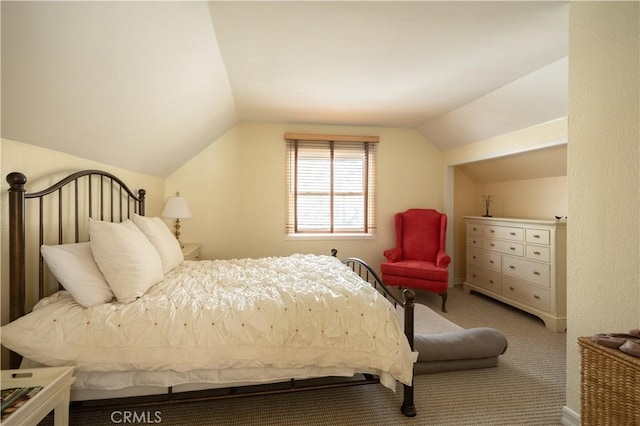 bedroom featuring lofted ceiling and light colored carpet