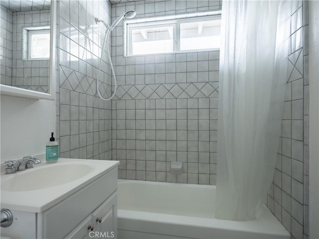 bathroom featuring shower / bath combination with curtain and vanity