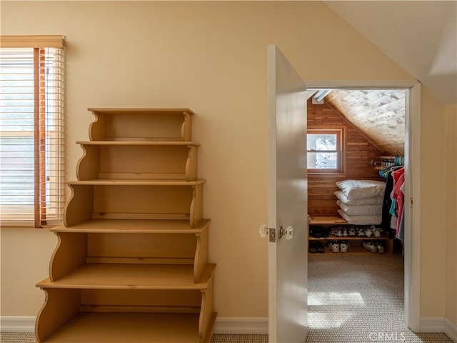 interior space with vaulted ceiling and carpet floors