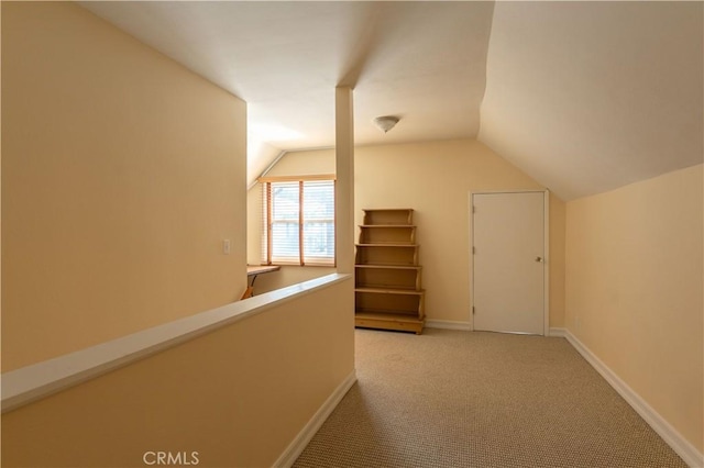 additional living space with carpet floors and vaulted ceiling