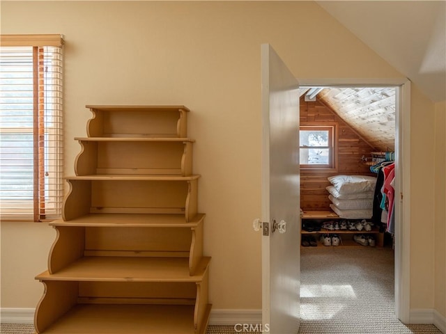 interior space featuring lofted ceiling and carpet flooring