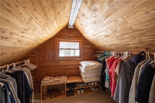 spacious closet featuring lofted ceiling with beams and carpet floors