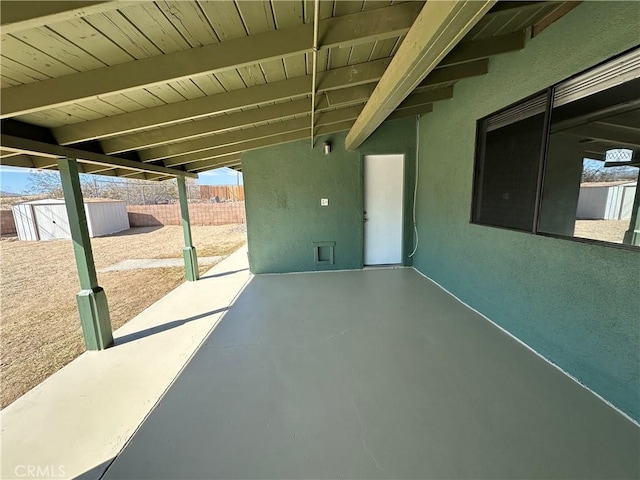 view of patio with a storage shed