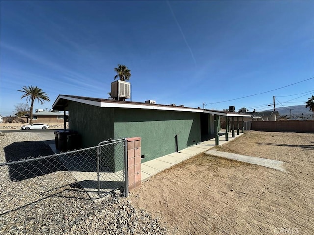 view of side of home featuring cooling unit