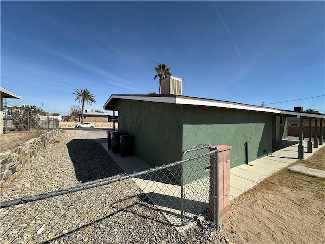 view of side of home with central air condition unit