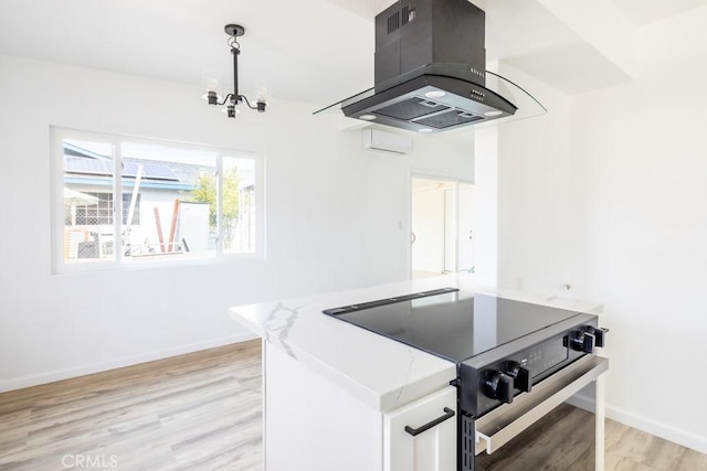 kitchen featuring white cabinetry, island range hood, light hardwood / wood-style flooring, electric range, and pendant lighting