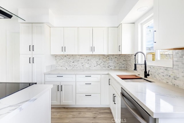 kitchen with white cabinetry, dishwasher, sink, and light stone countertops