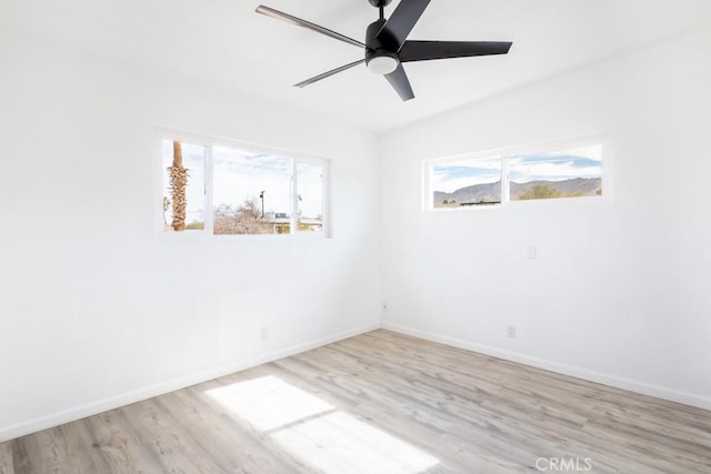 empty room with ceiling fan and light wood-type flooring