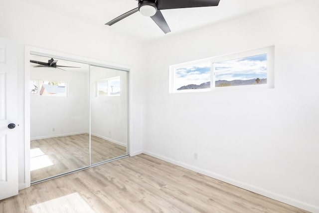 unfurnished bedroom featuring a closet, ceiling fan, and light hardwood / wood-style flooring