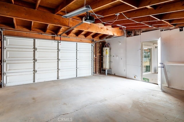 garage featuring strapped water heater and a garage door opener