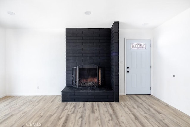 interior space with a fireplace and light wood-type flooring