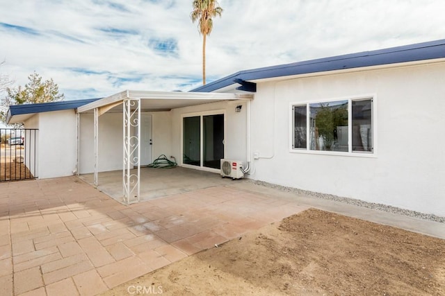 back of house with a patio area and ac unit