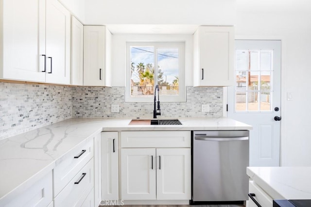 kitchen with sink, dishwasher, white cabinetry, tasteful backsplash, and a healthy amount of sunlight