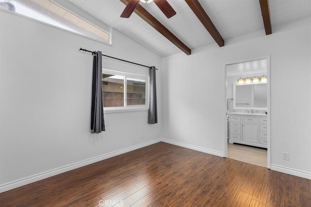 unfurnished bedroom featuring hardwood / wood-style flooring, ensuite bathroom, sink, and vaulted ceiling with beams