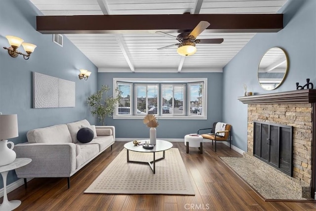 living room featuring ceiling fan, a fireplace, dark hardwood / wood-style flooring, and vaulted ceiling with beams