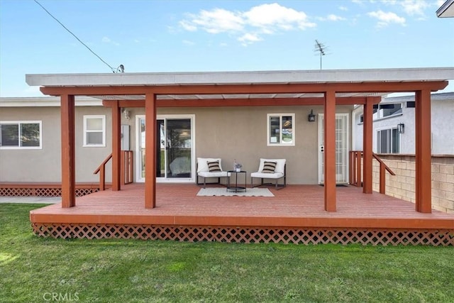 rear view of property with a deck and a lawn