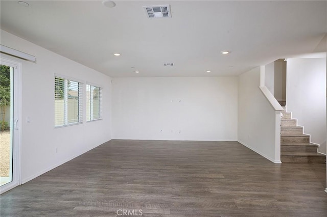 empty room with dark hardwood / wood-style flooring