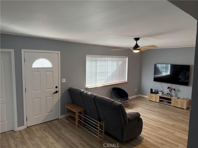 living room featuring light hardwood / wood-style flooring and ceiling fan