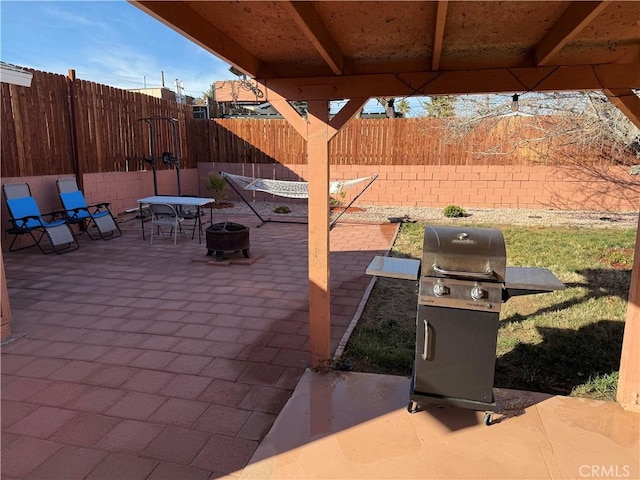 view of patio with a fire pit and grilling area