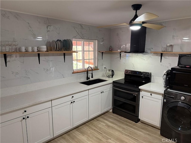 kitchen with sink, white cabinetry, double oven range, washer / clothes dryer, and backsplash