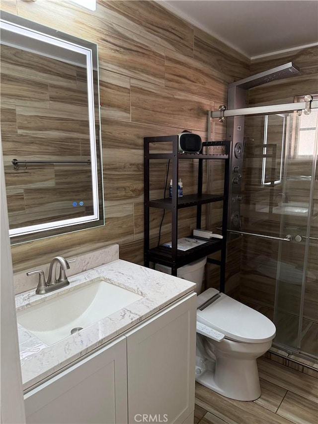 bathroom with vanity, toilet, and an enclosed shower