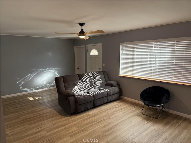 living room featuring ceiling fan and light wood-type flooring