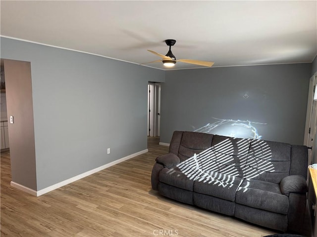 living room with light hardwood / wood-style flooring and ceiling fan