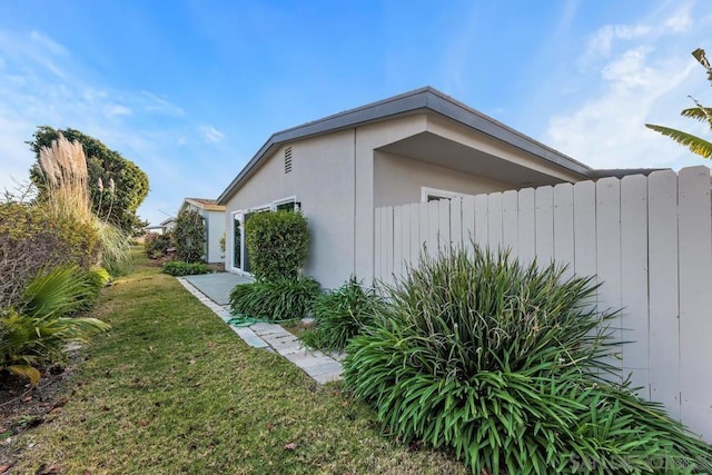 view of side of property with a yard