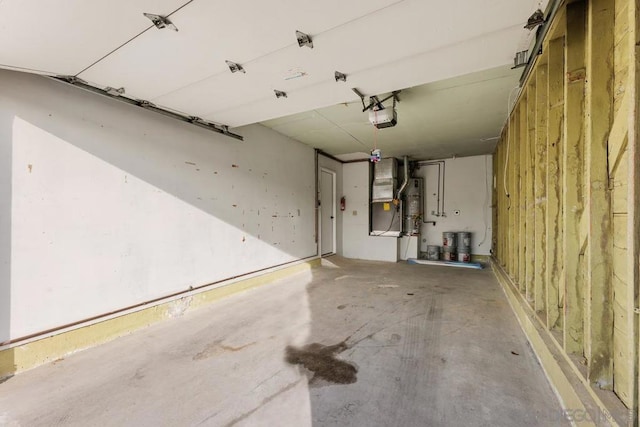 garage with a garage door opener and strapped water heater